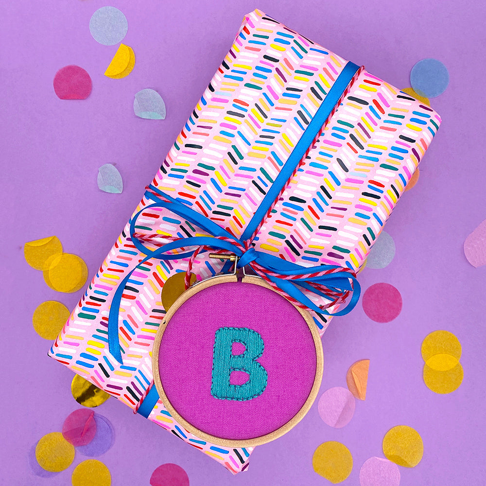 personalised hand embroidery design used as a gift tag on a present