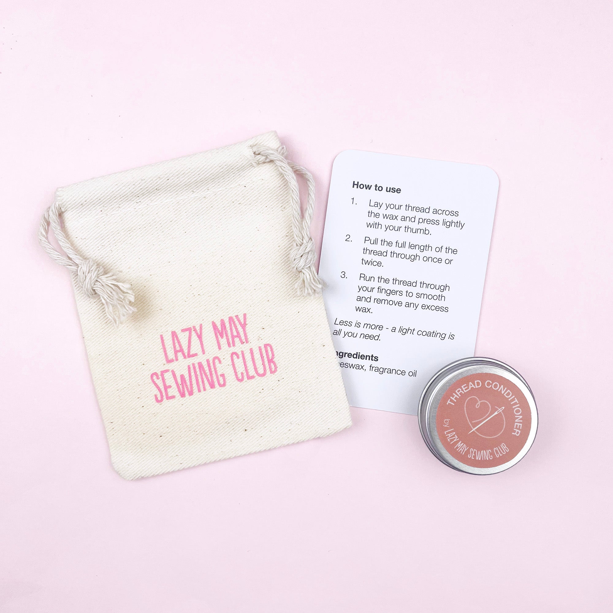 Lazy May Sewing Club thread conditioner with packaging and instructions on a pink background