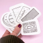 A fan of British biscuit embroidery patterns printed on dissolving fabric, ready for stitching. These modern embroidery designs make personalising fabric projects simple and fun.