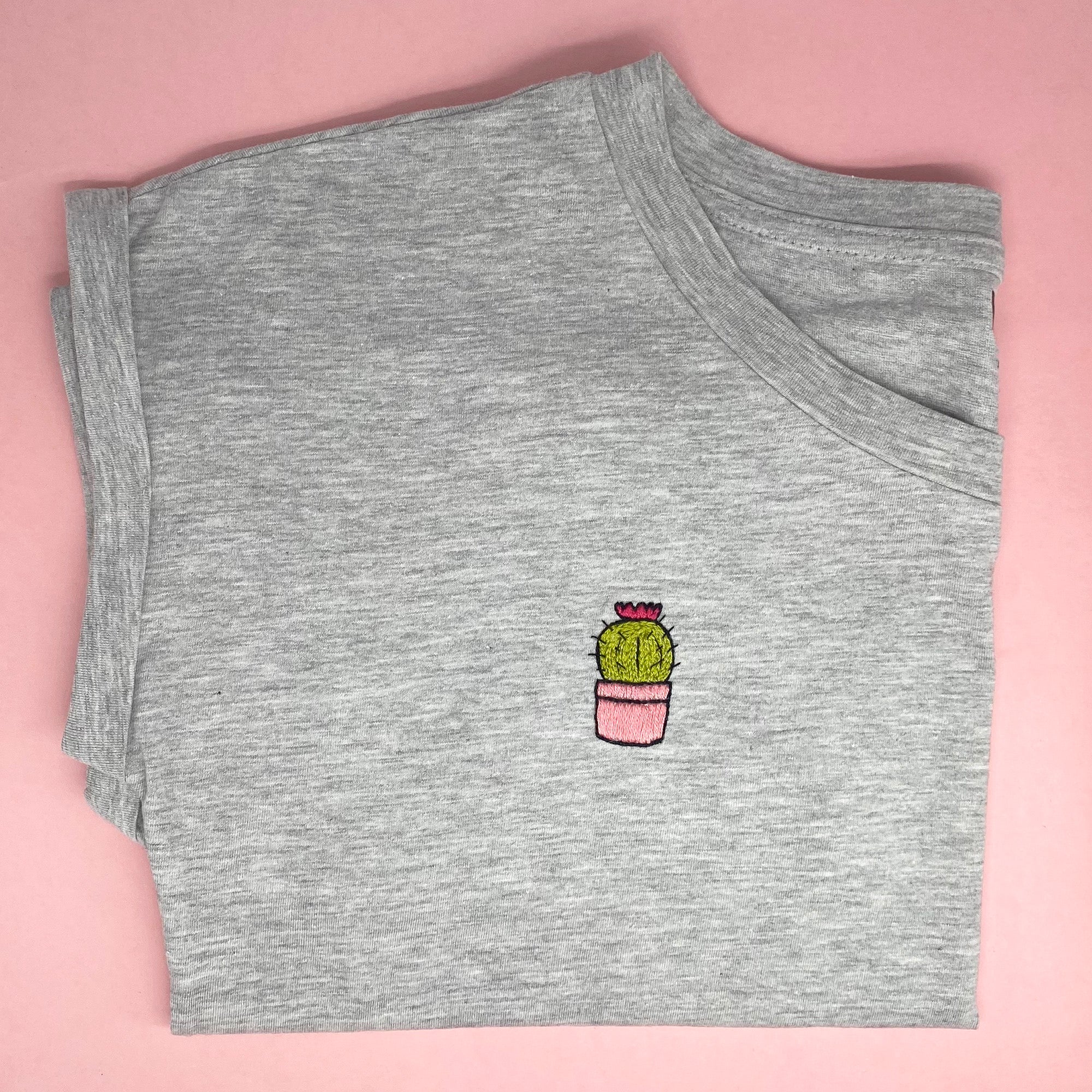 A cute cactus design from the house plants stick and stitch embroidery set, stitched onto a grey T-shirt using water-soluble embroidery patterns.