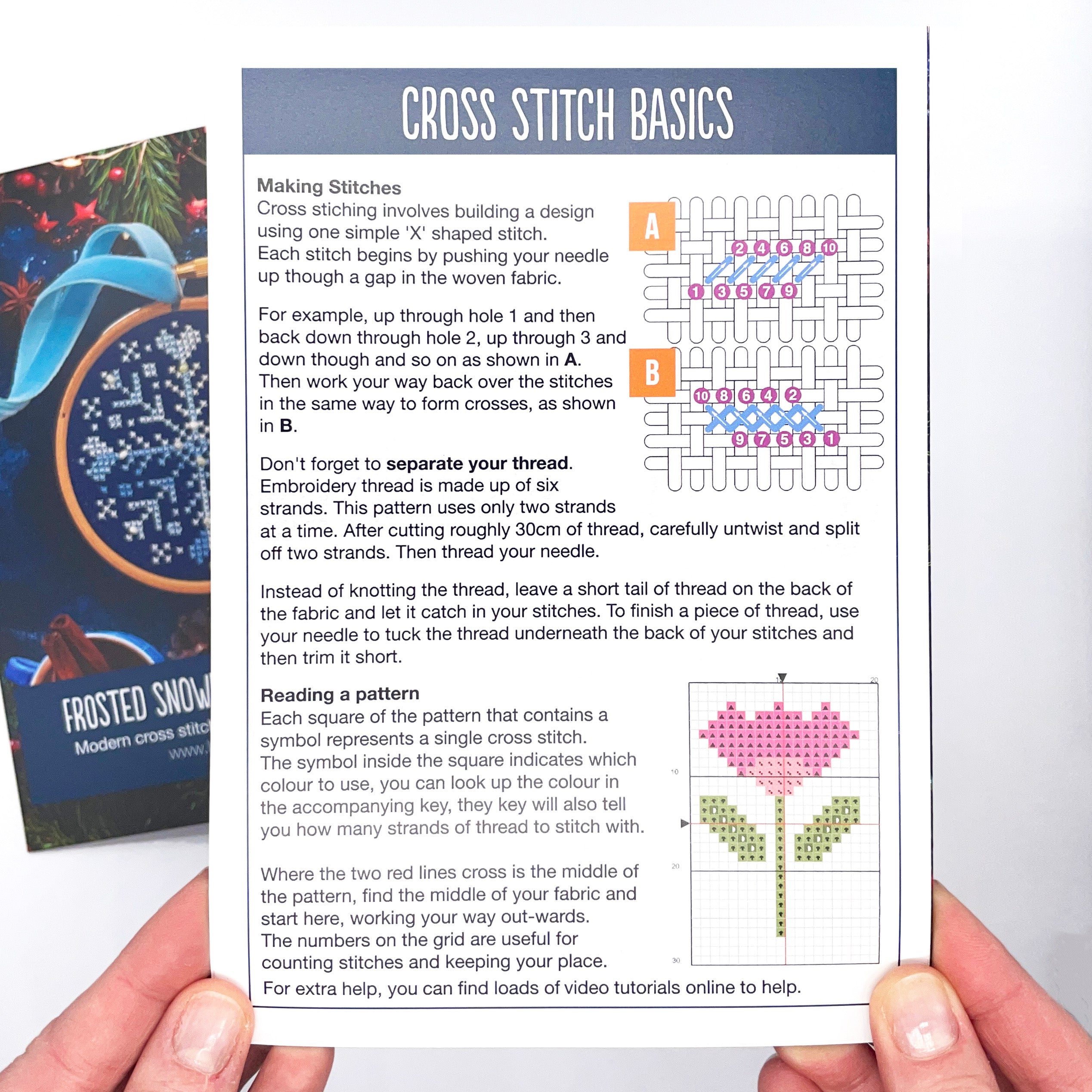Instruction sheet explaining cross stitch basics with diagrams and a pixelated pink flower pattern from Beaded Snowflake: Christmas Cross Stitch Kit