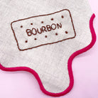 Close-up of a stitched Bourbon biscuit embroidery pattern on fabric, created using a dissolving embroidery pattern. A playful addition to modern embroidery projects.