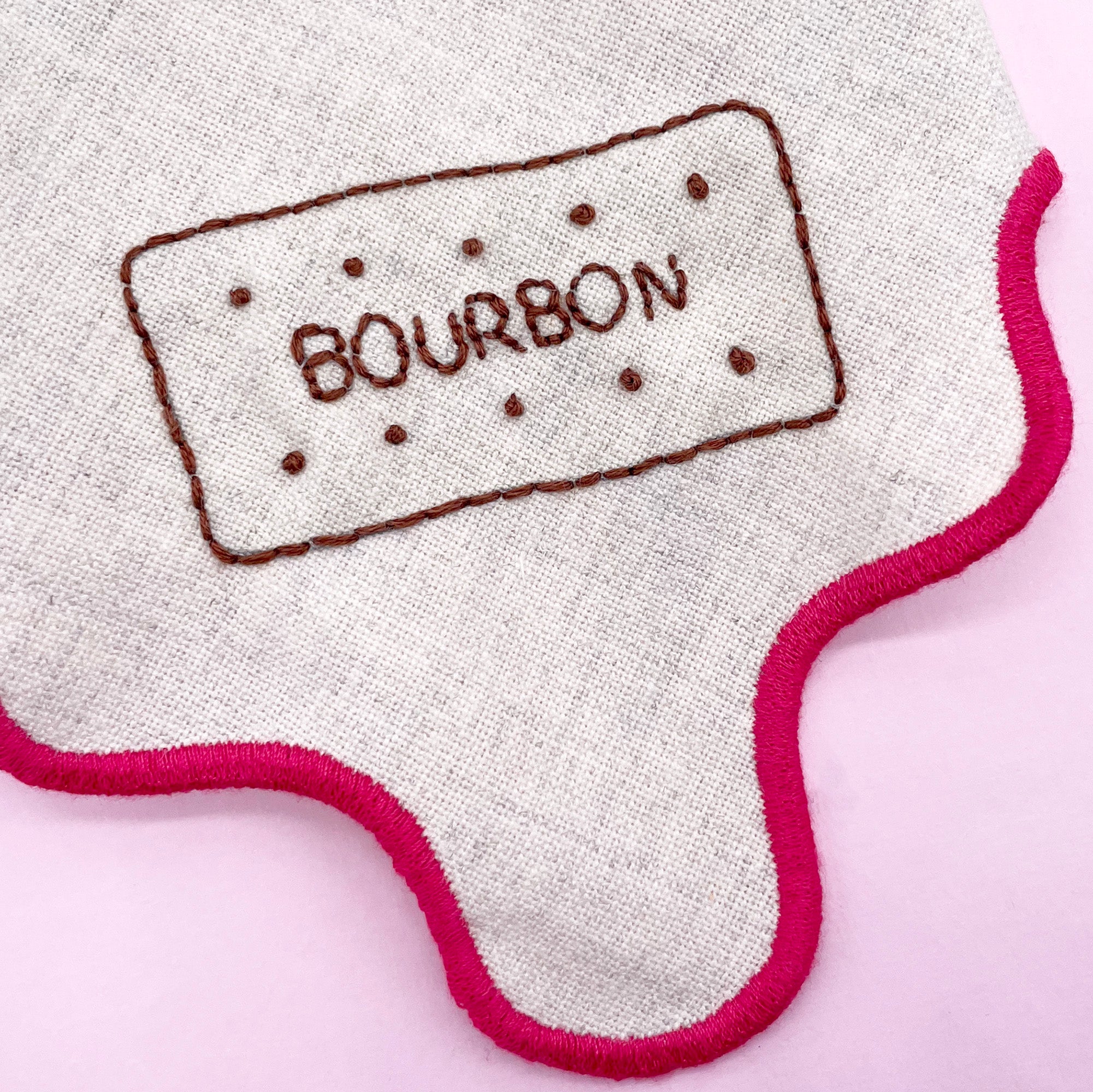 Close-up of a stitched Bourbon biscuit embroidery pattern on fabric, created using a dissolving embroidery pattern. A playful addition to modern embroidery projects.