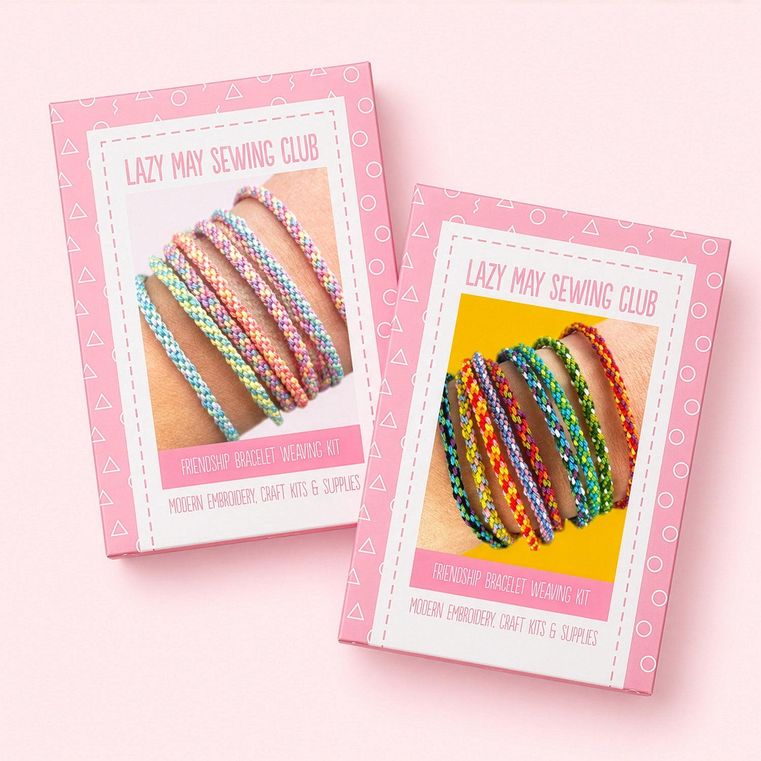 Two pink boxes for a 'Lazy May Sewing Club' friendship bracelet weaving kit, shown on a light pink background. The boxes feature photos of colorful woven bracelets and text indicating they contain modern embroidery craft kits and supplies.