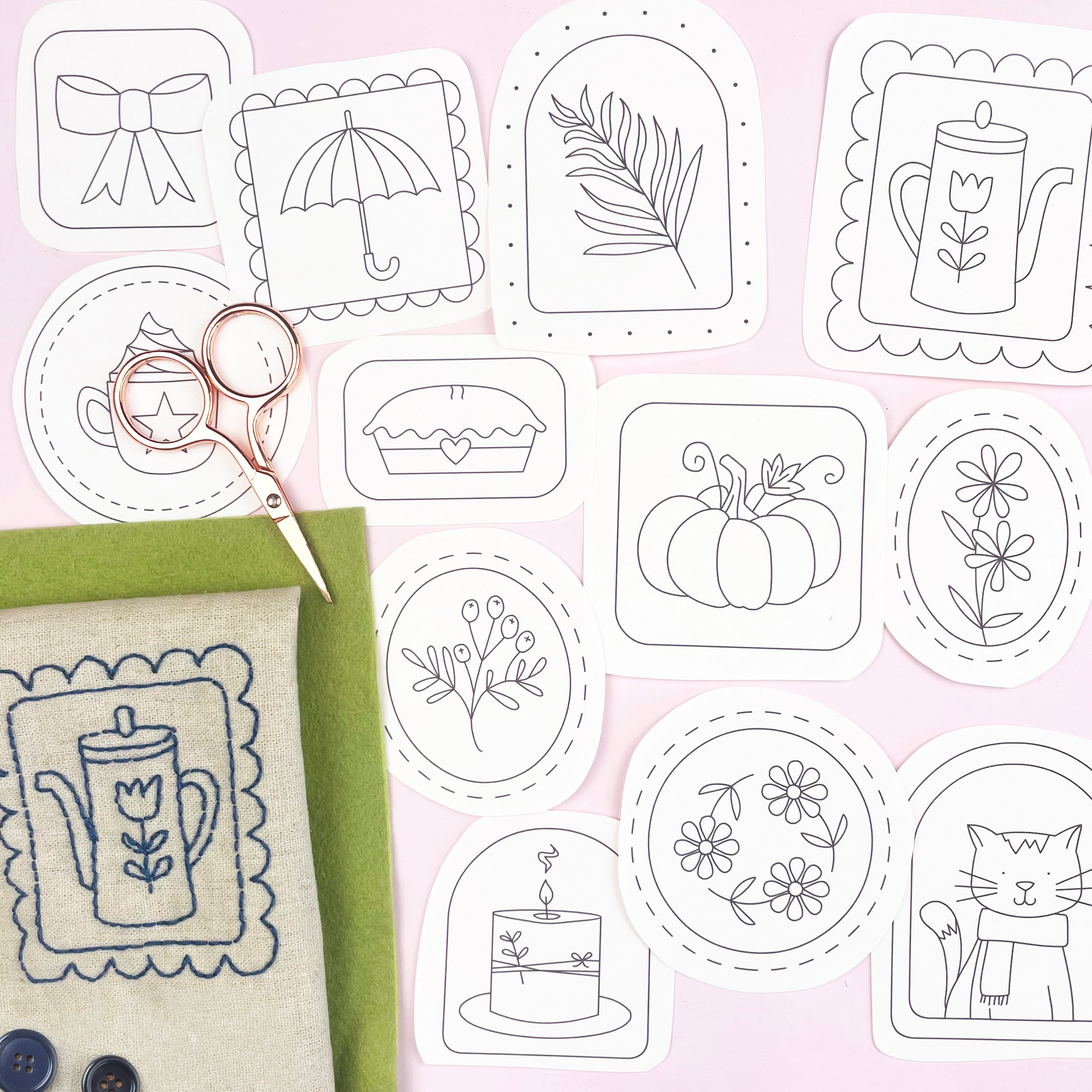 Set of autumn or fall themed embroidery patterns on a pink background with fabric and scissors.