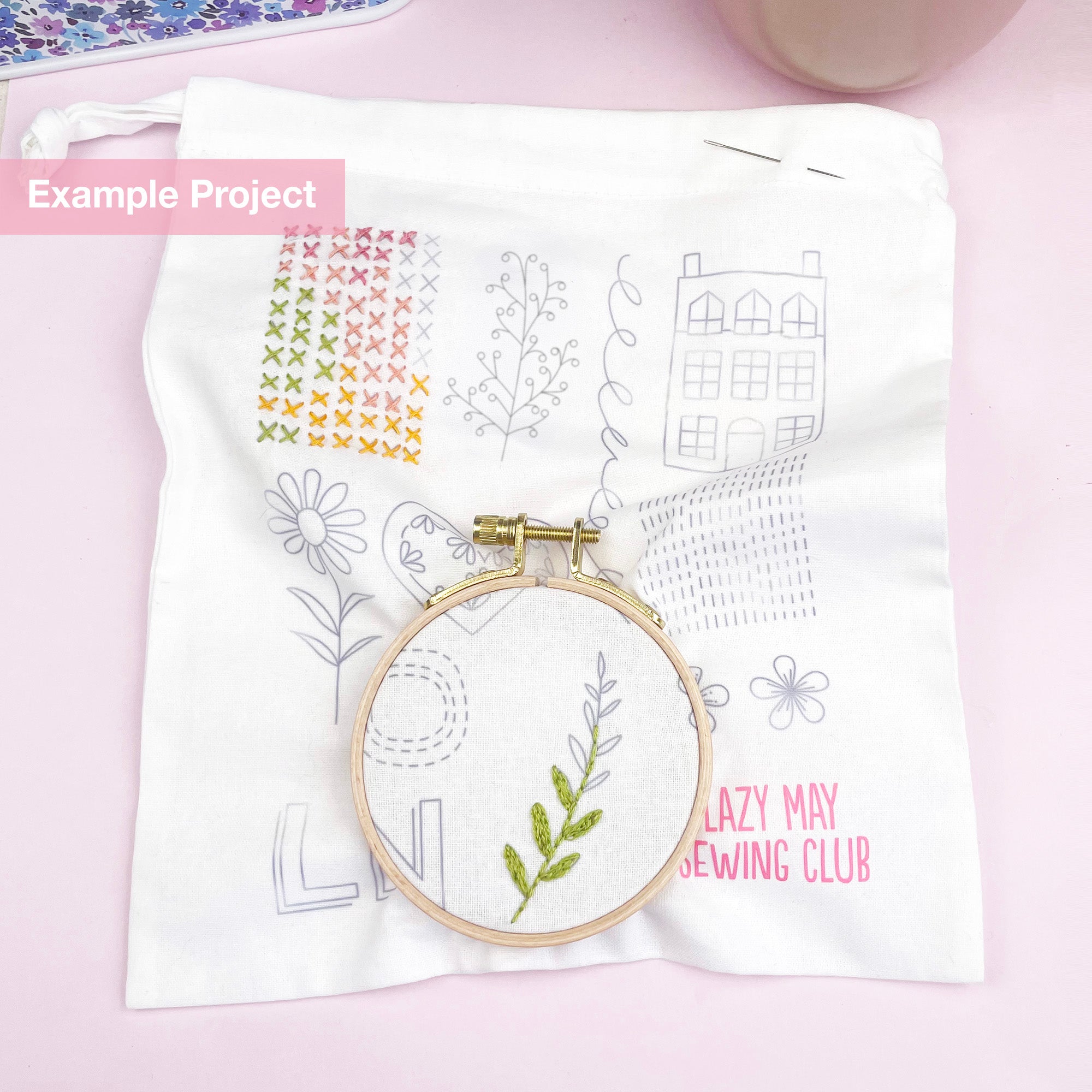 Beginner-friendly embroidery project showing natural thread stitching on a fabric with floral and geometric patterns.