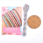 Friendship Bracelets Kit contents including wooden loom, instruction card and pre-cut pastel threads – ideal kids bracelet making set.