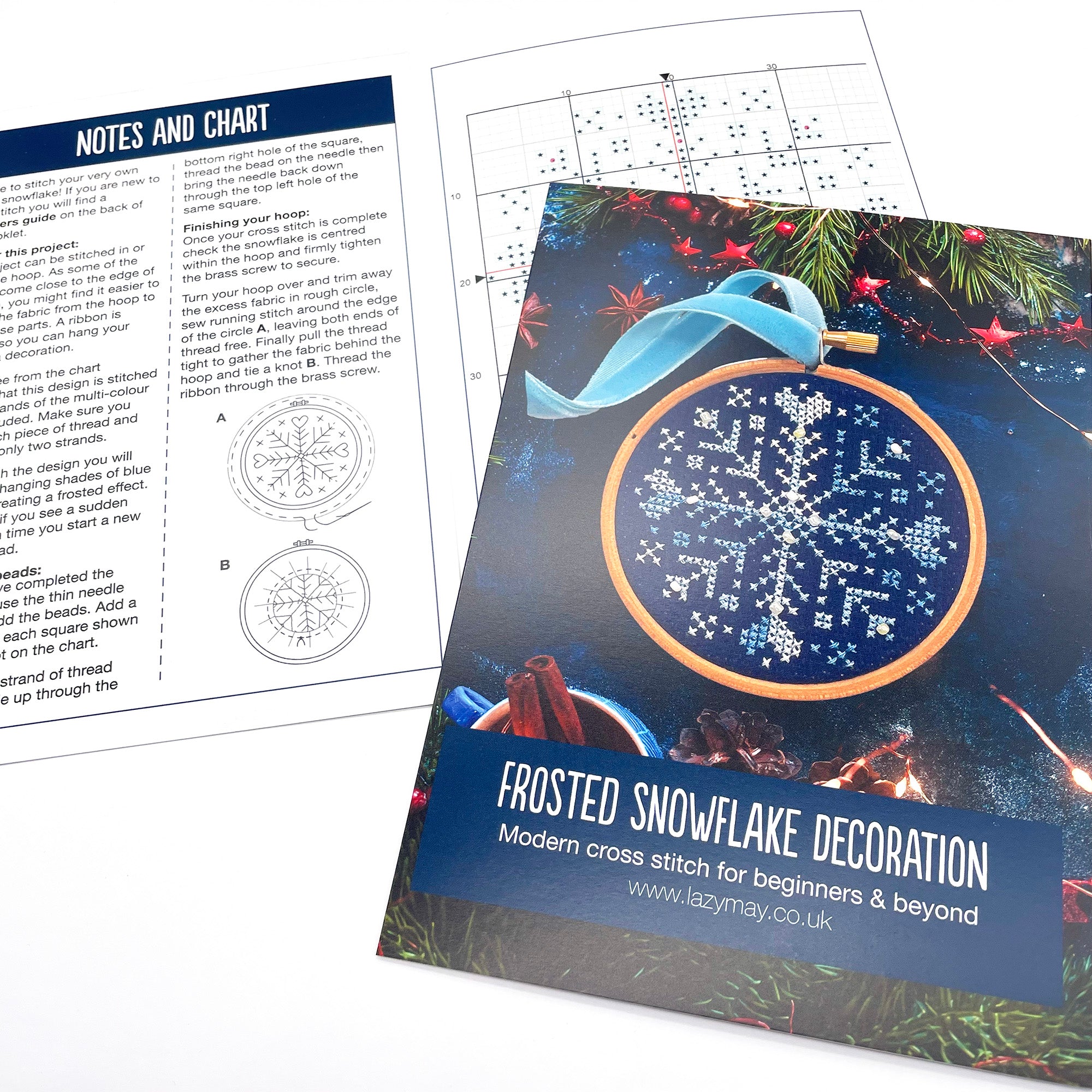 Beaded Snowflake: Christmas Cross Stitch Kit showing stitched snowflake pattern with instructions and festive background