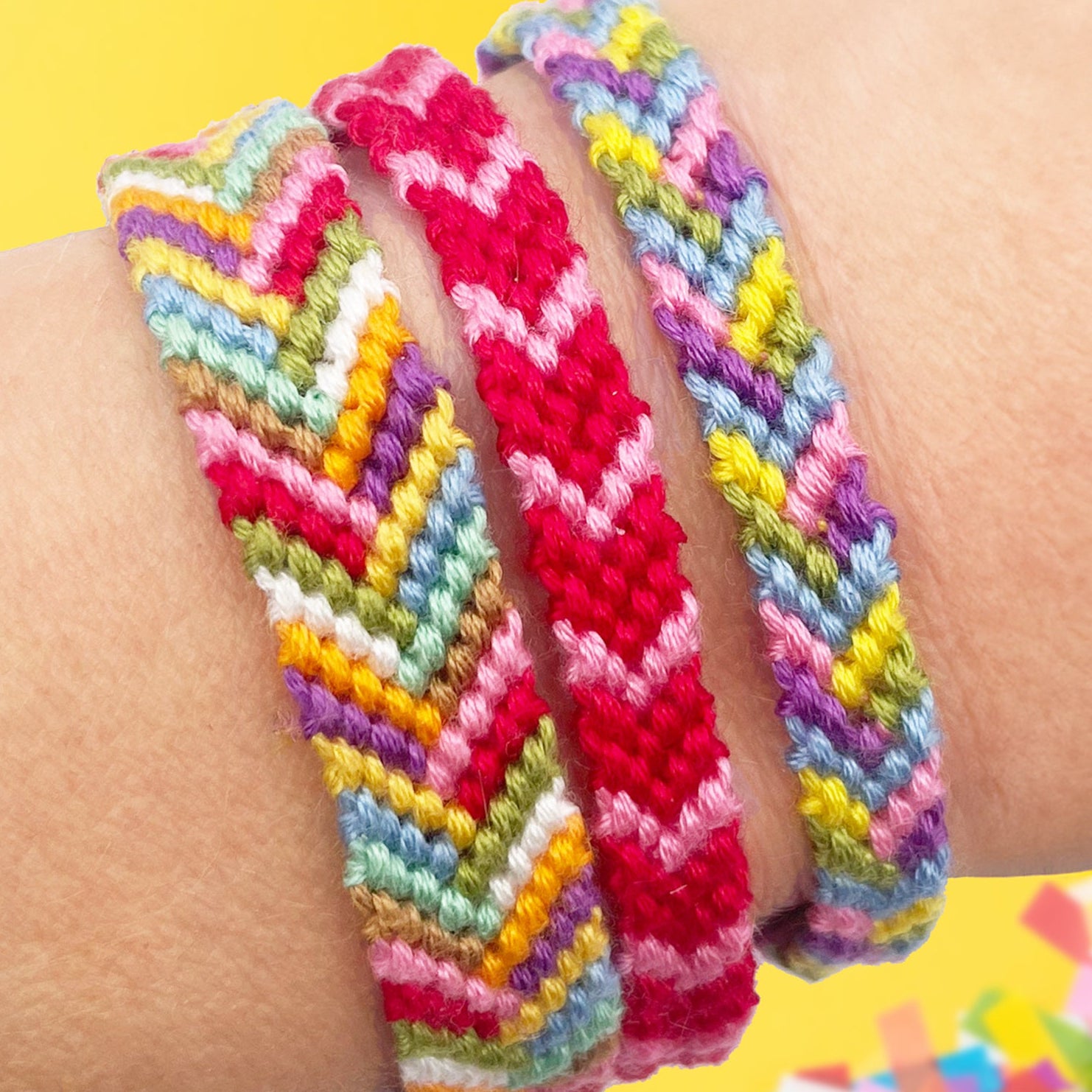 Handmade chevron friendship bracelets in rainbow colours, worn on a wrist. DIY bracelet making kit for beginners, craft lovers, and gifts.
