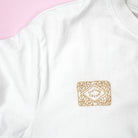Embroidered custard cream biscuit design stitched onto a white T-shirt using a stick and stitch embroidery pattern. This modern embroidery pattern is perfect for customising clothing with dissolving embroidery designs.