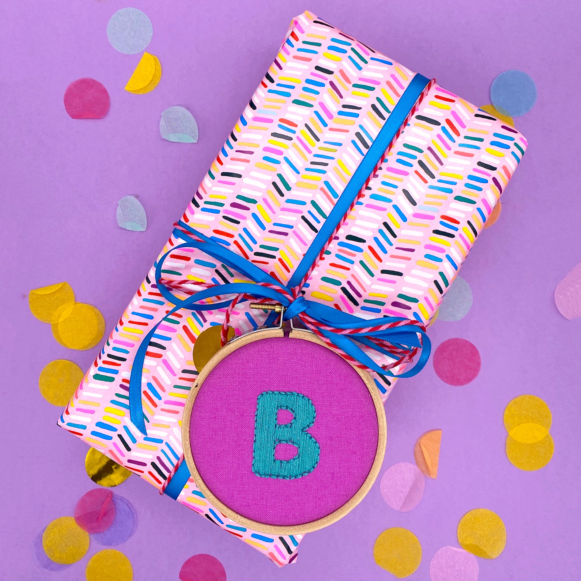 handmade embroidery hoop with letter B attached to a gift