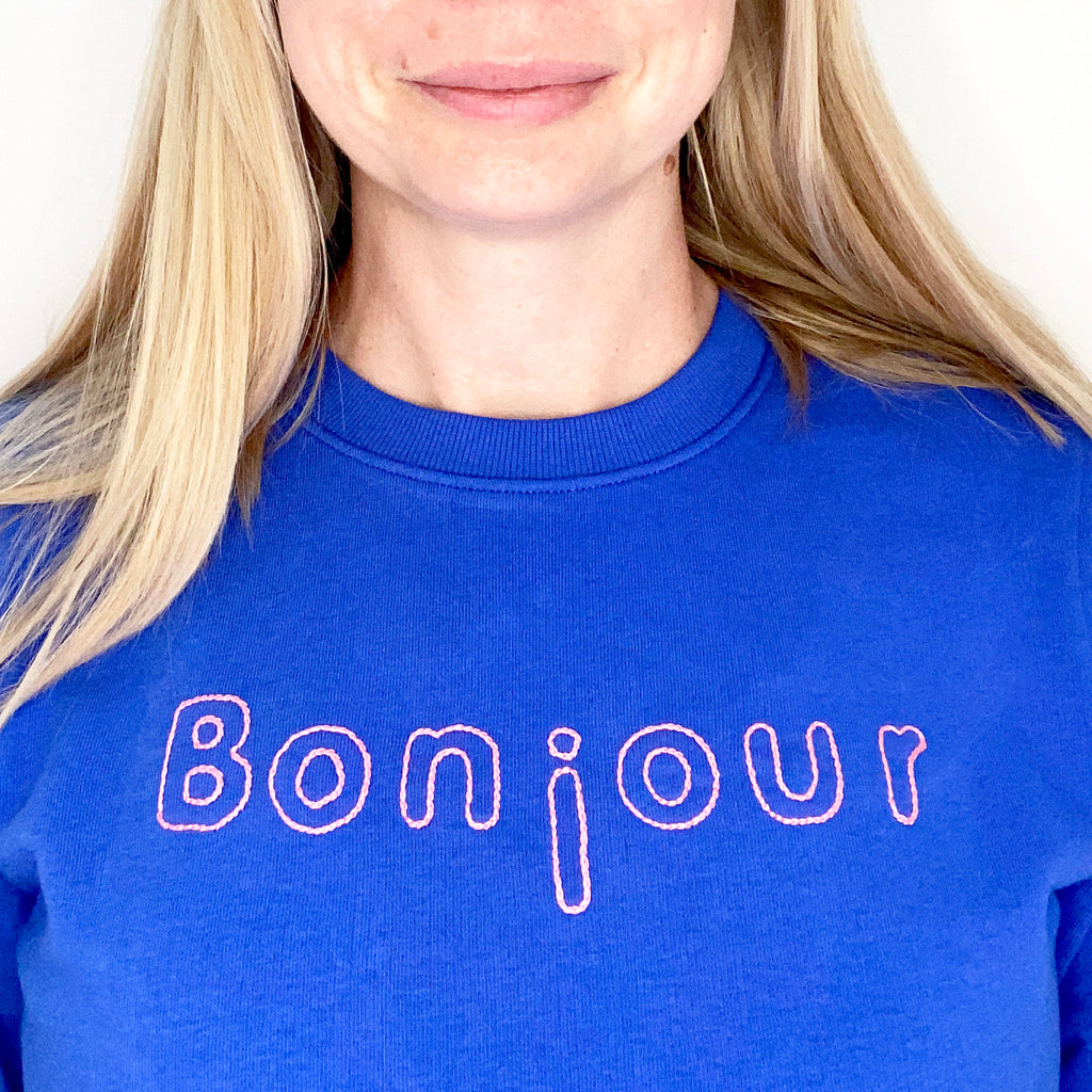 Hand embroidered sweater with the word bonjour stitched across it in pink design from iron on embroidery transfers iron on embroidery patterns with alphabet theme letters text
