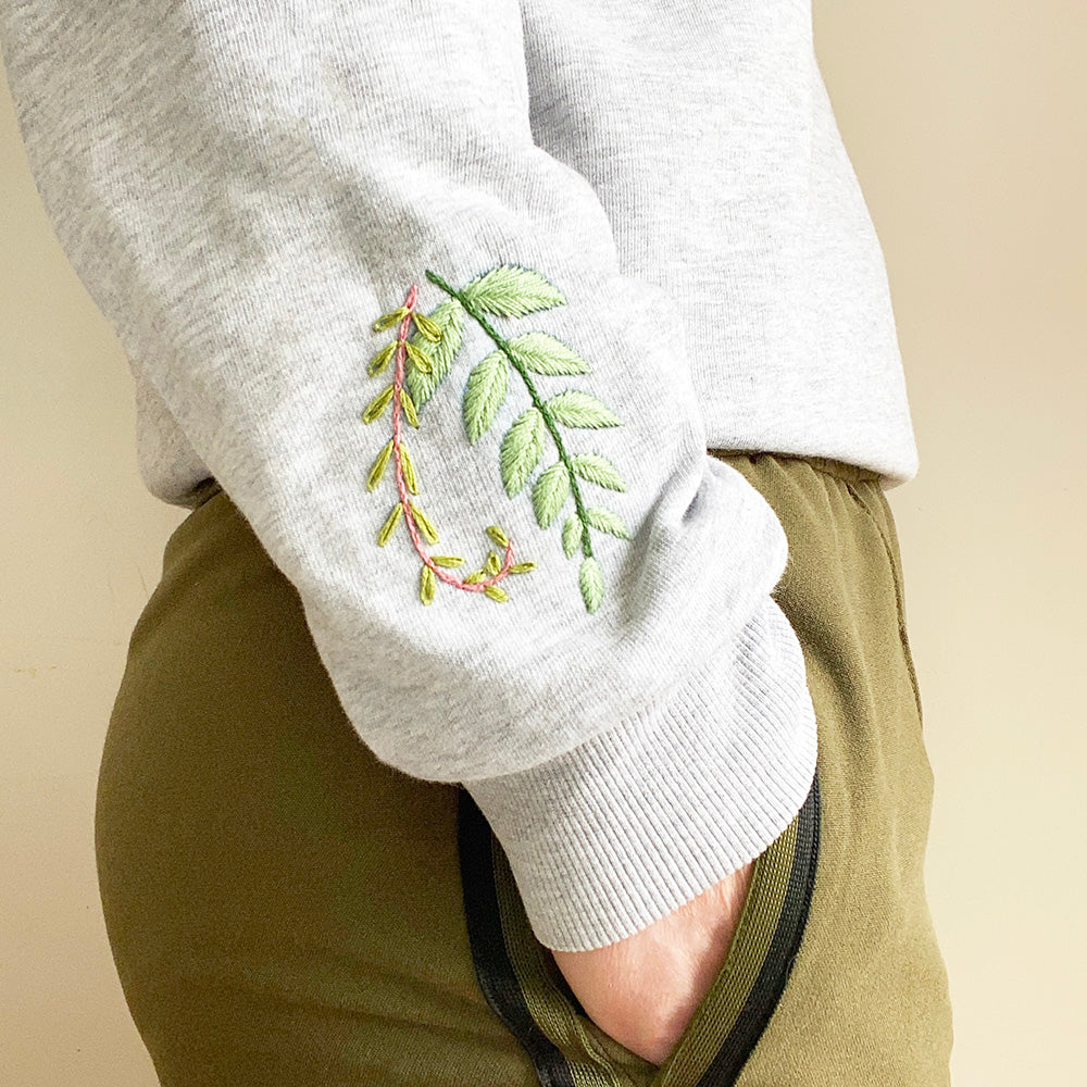 sweater hand embroidered with botanical leaf designs