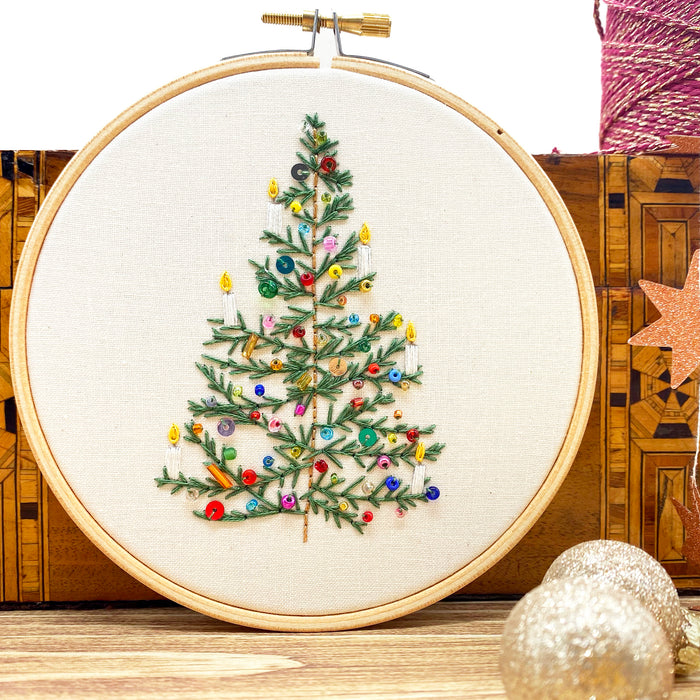 Beaded Christmas Tree Embroidery Kit with a stitched green tree decorated with colourful beads, sequins and candles.