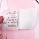 Embroidery pattern of a sweater held over pink fabric