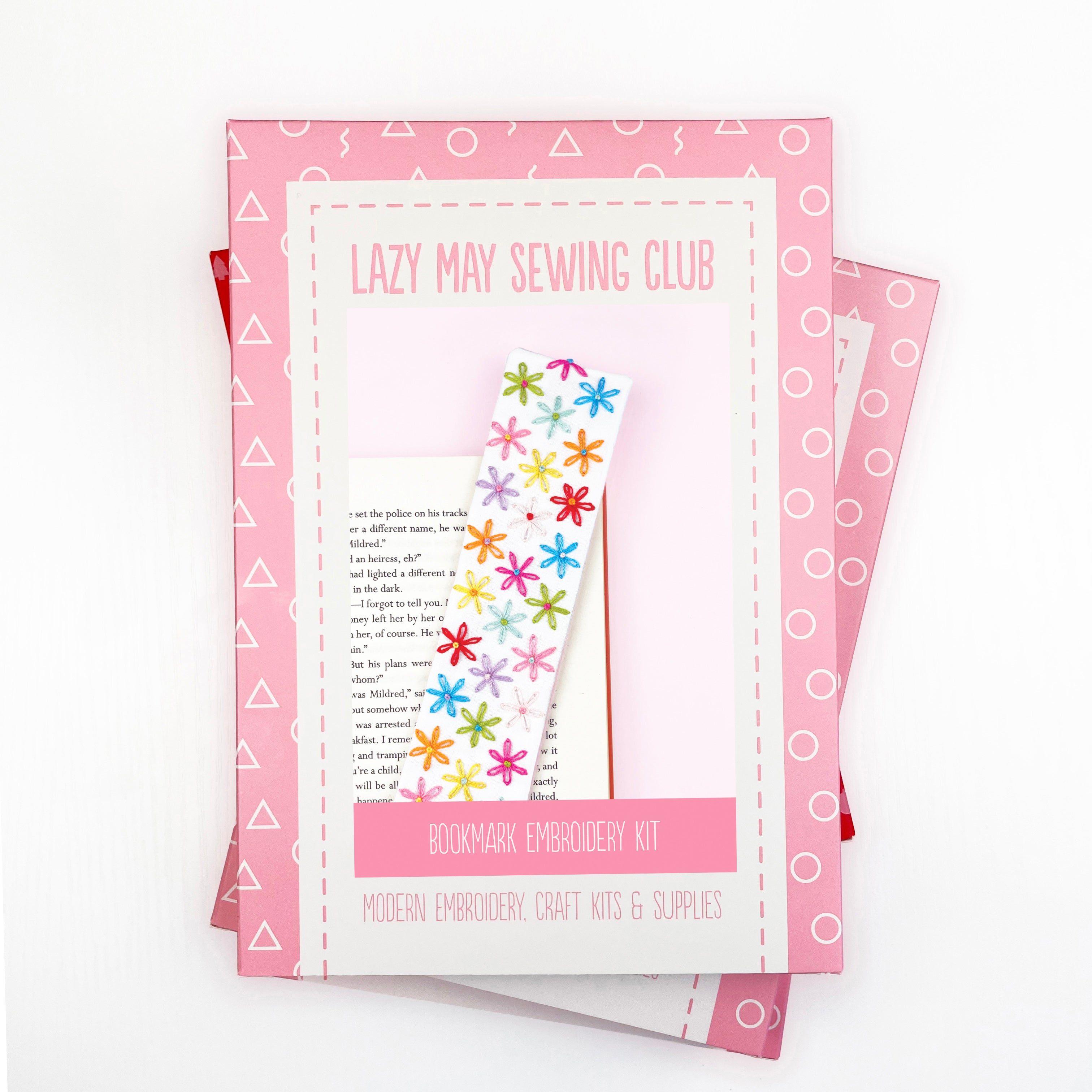 Embroidery kit packaging with colorful flowers and text on a white background