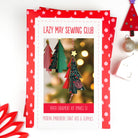 Lazy May Sewing Club paper ornament kit packaging with Christmas tree decorations on a white background.