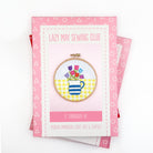 Embroidery kit packaging with a design of tulips and a cup on a white background