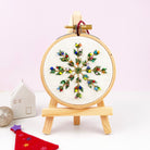 Embroidery hoop with colorful christmas design on a white background