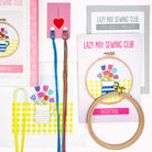 Lazy May Sewing Club embroidery kit with hoop, thread, and instructions on a white background