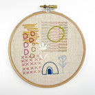 Hand embroidery hoop featuring abstract floral and geometric stitches in various colors Iron-On Embroidery Patterns: Slow Stitching Textures