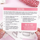 Instructions card for stick and stitch patterns held by hands with a red and white fabric in the background.