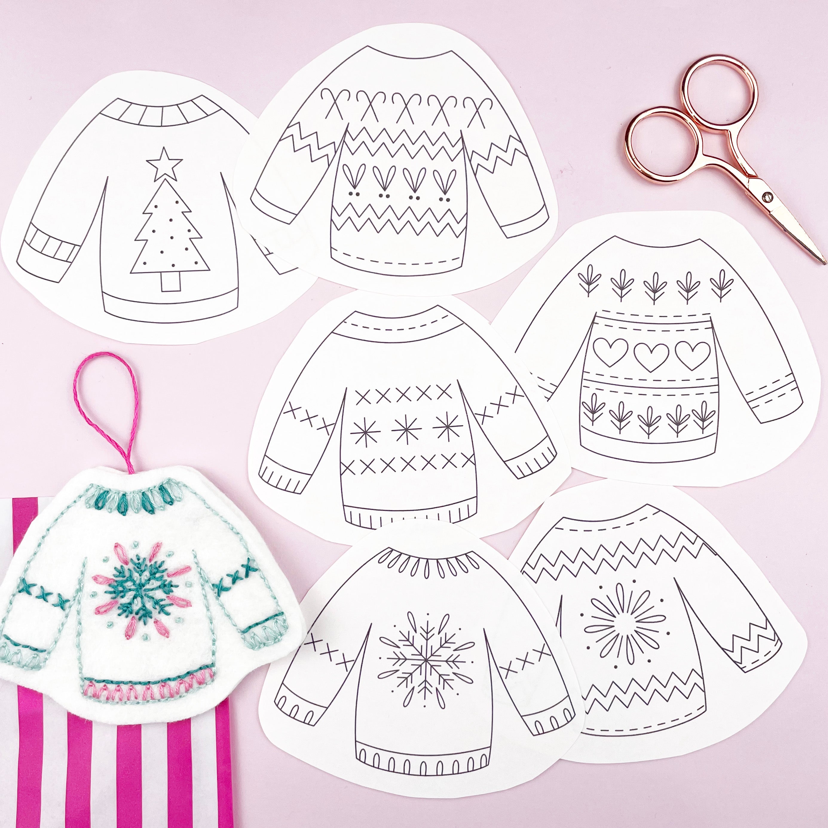 embroidery patterns of Christmas sweaters with patterns on a pink background.