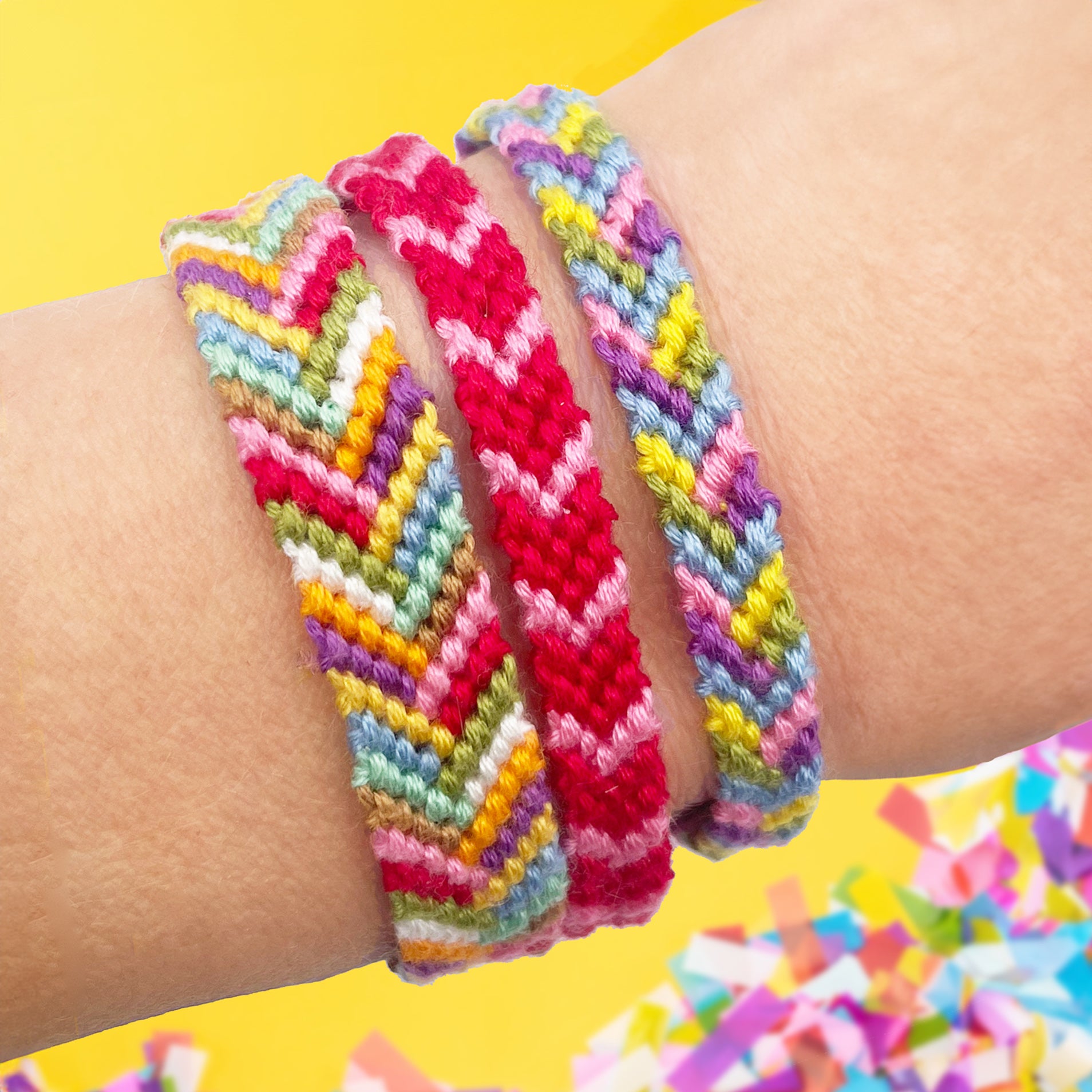 Handmade chevron friendship bracelets in rainbow colours, worn on a wrist. DIY bracelet making kit for beginners, craft lovers, and gifts.