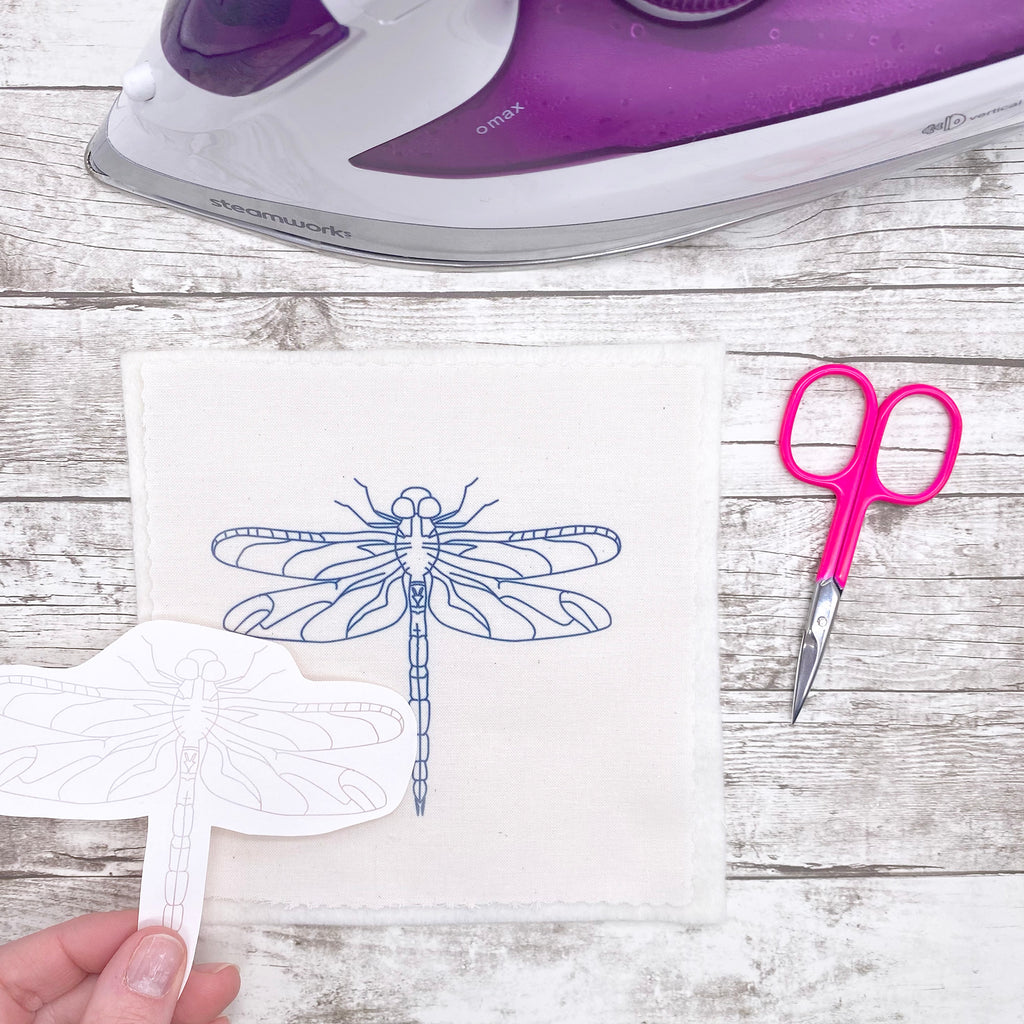 Embroidery pattern of a dragonfly ironed onto fabric